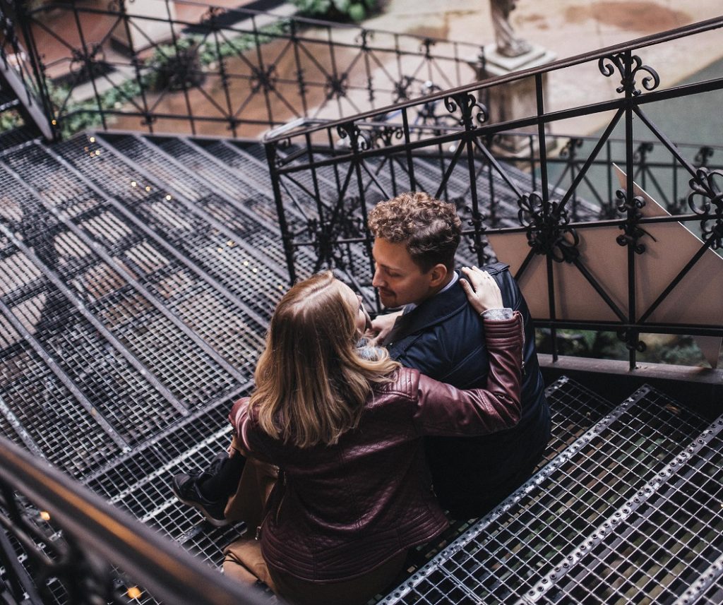 happy couple whispering sweet nothings