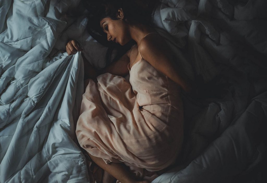 girl in blankets imagining the two of them together