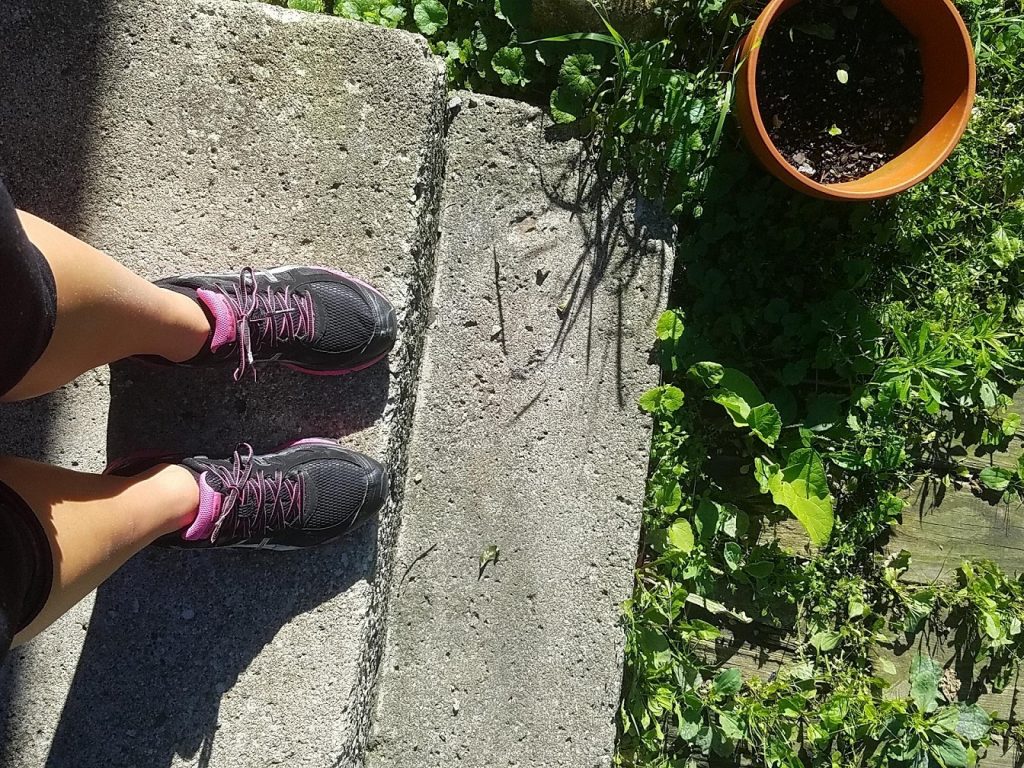 persons shoes on concrete