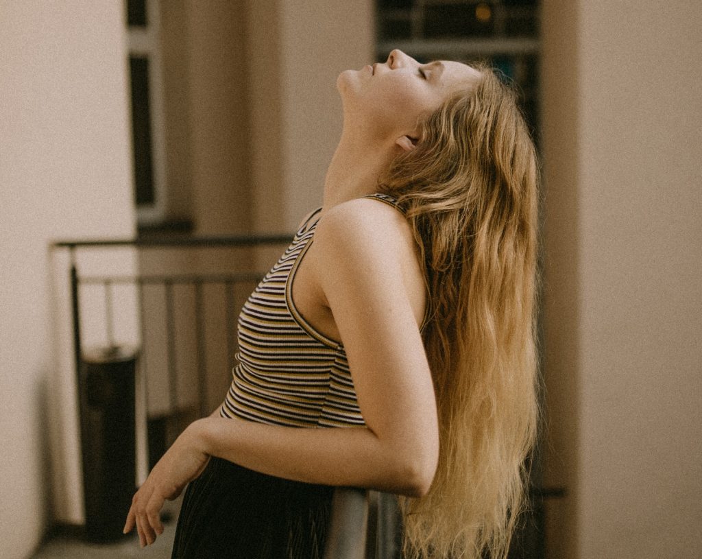 peaceful girl leaning back thinking about mistakes you should actually make in your twenties