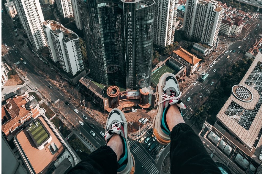 letter to the younger me dangling legs over the city