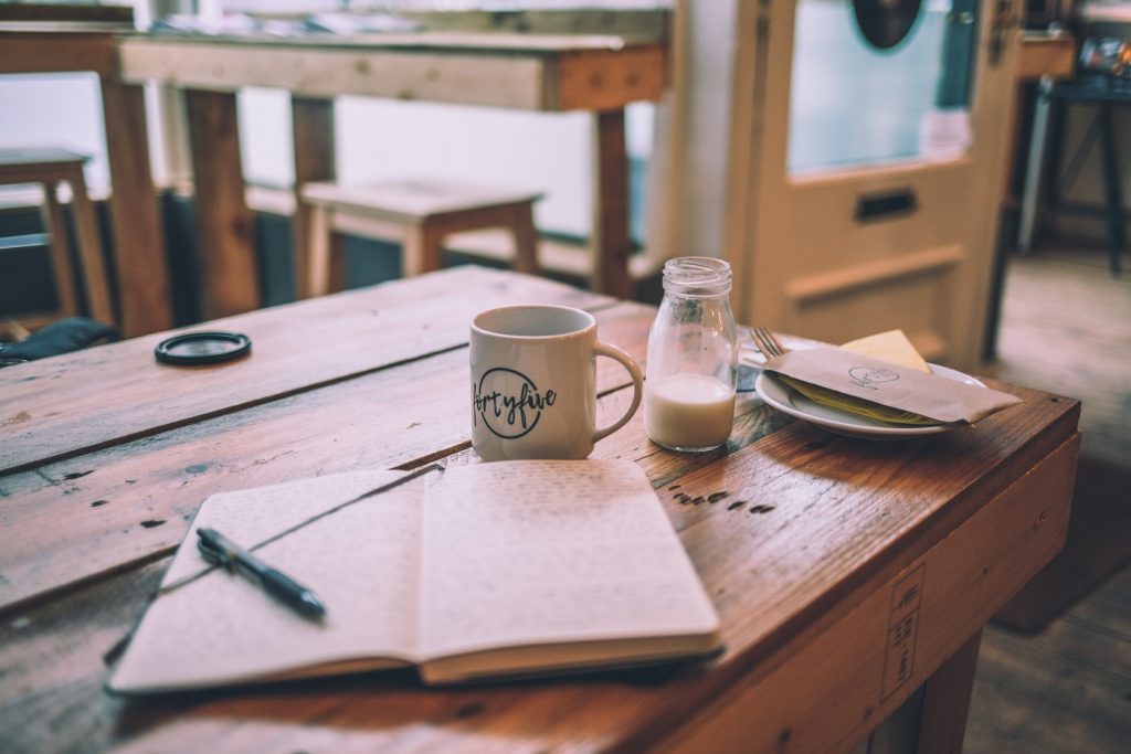 book and coffee on wooden table
