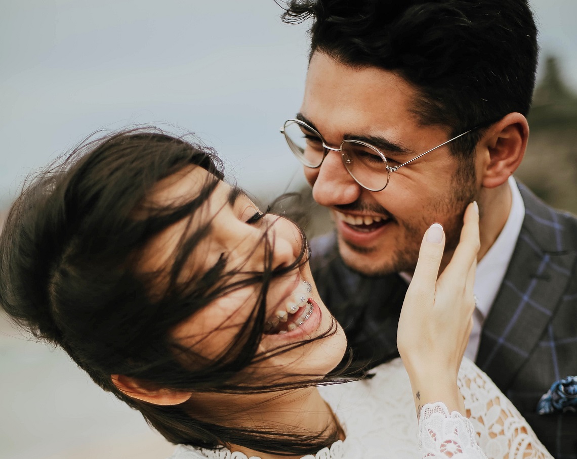 young couple laughing and smiling, love is an action