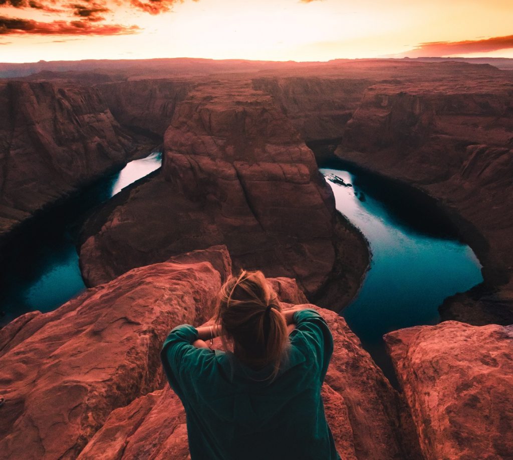 girl sitting on a mountain top