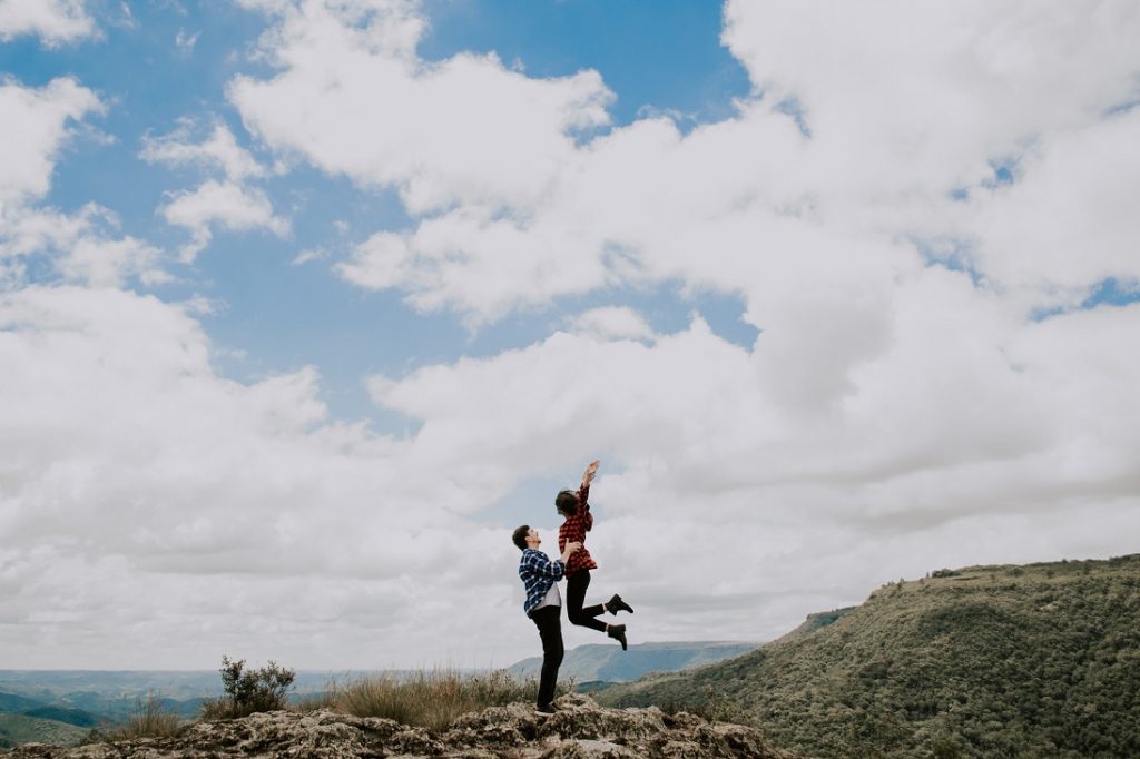girl jumping freely into man's arms