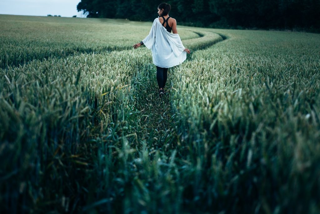 girl walking through cornfields