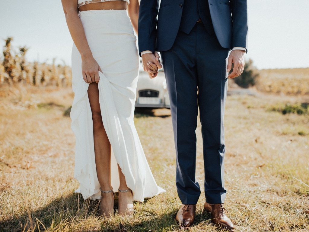 wedding couple standing in field