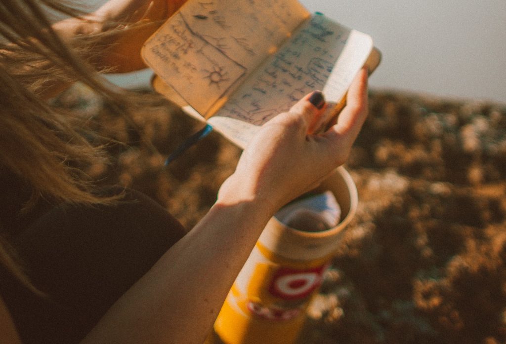 girl holding small notebook