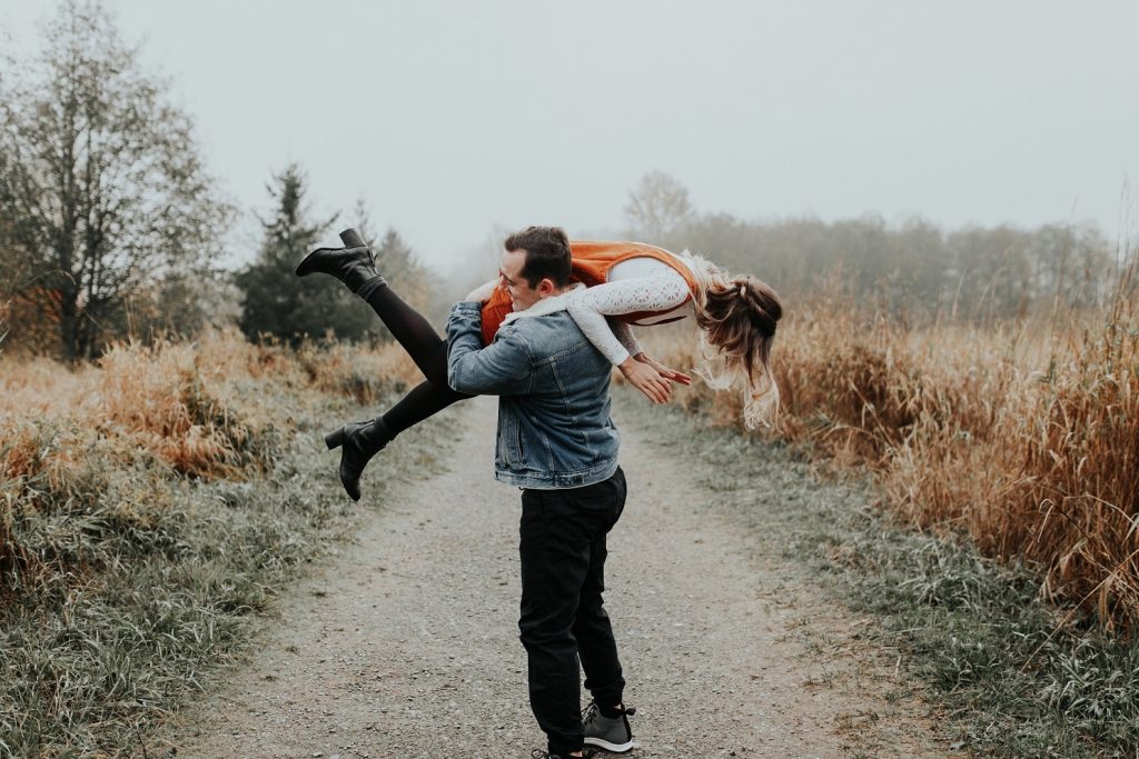 guy holding girl over his shoulder playfully