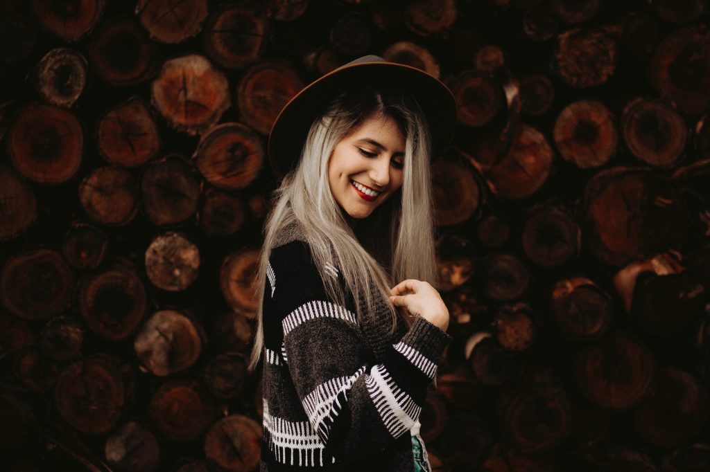 girl smiling looking down over shoulder