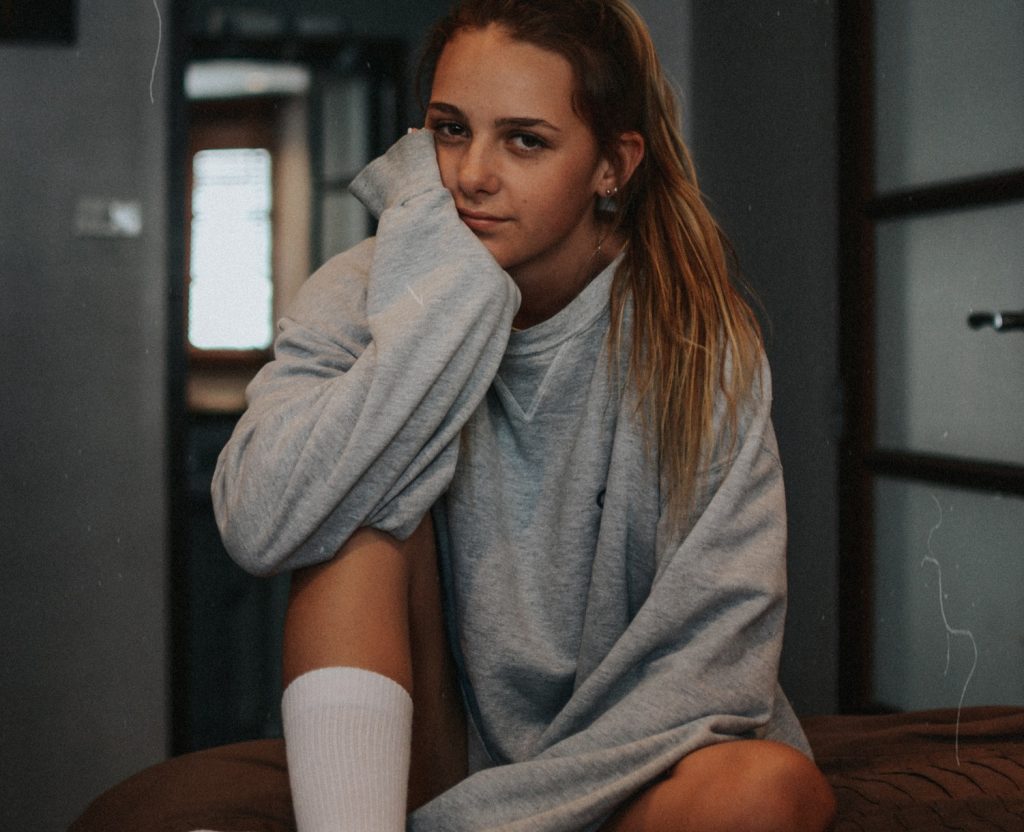 girl with smirk in comfy sweatshirt