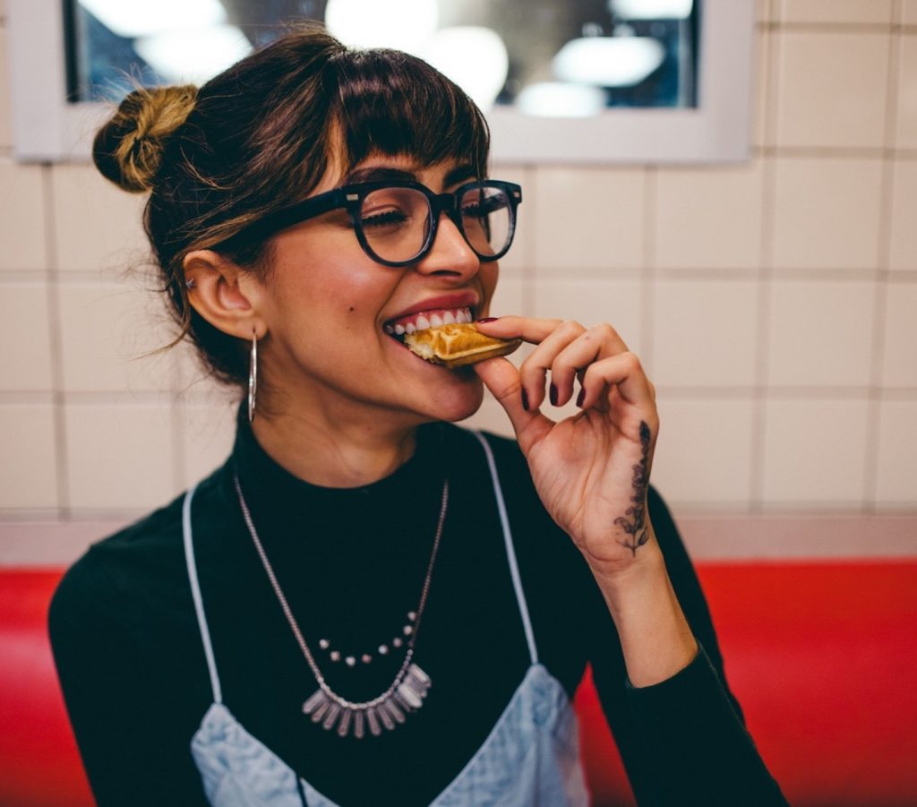 girl smiling eating food, prioritize yourself