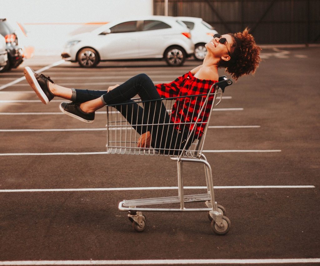 girl sitting in a shopping cart laughing, I believe in happiness