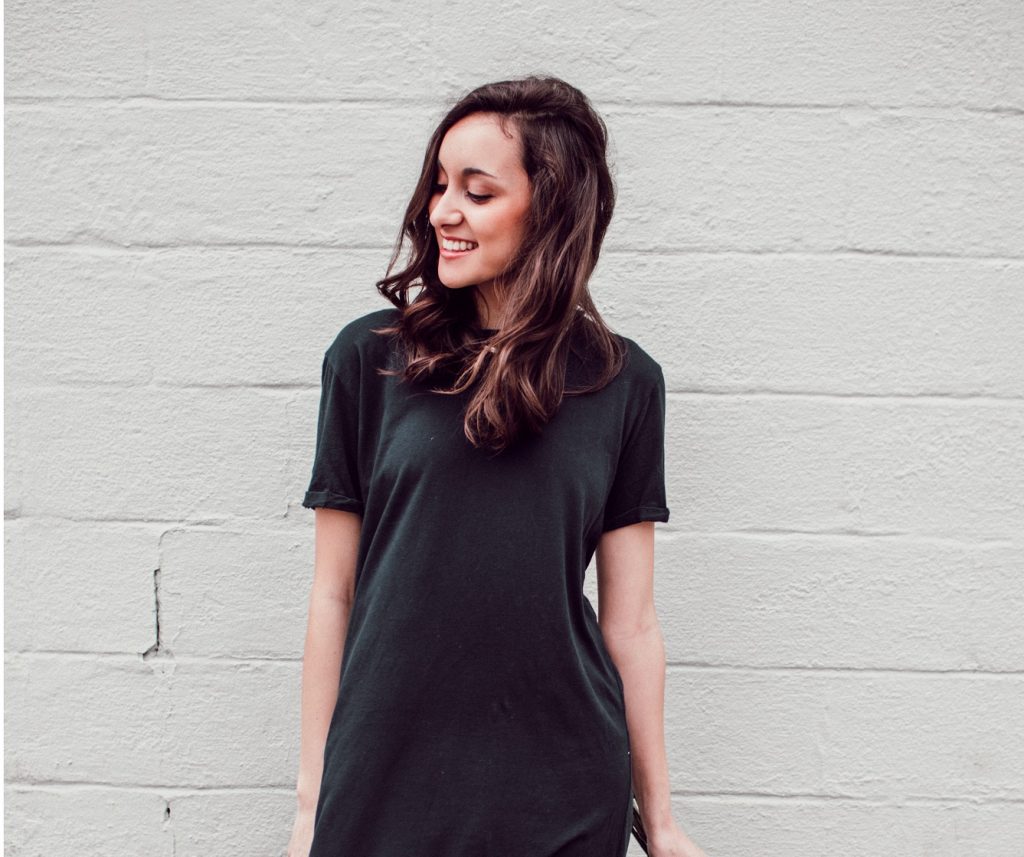 girl smiling looking down in black dress, I am blessed