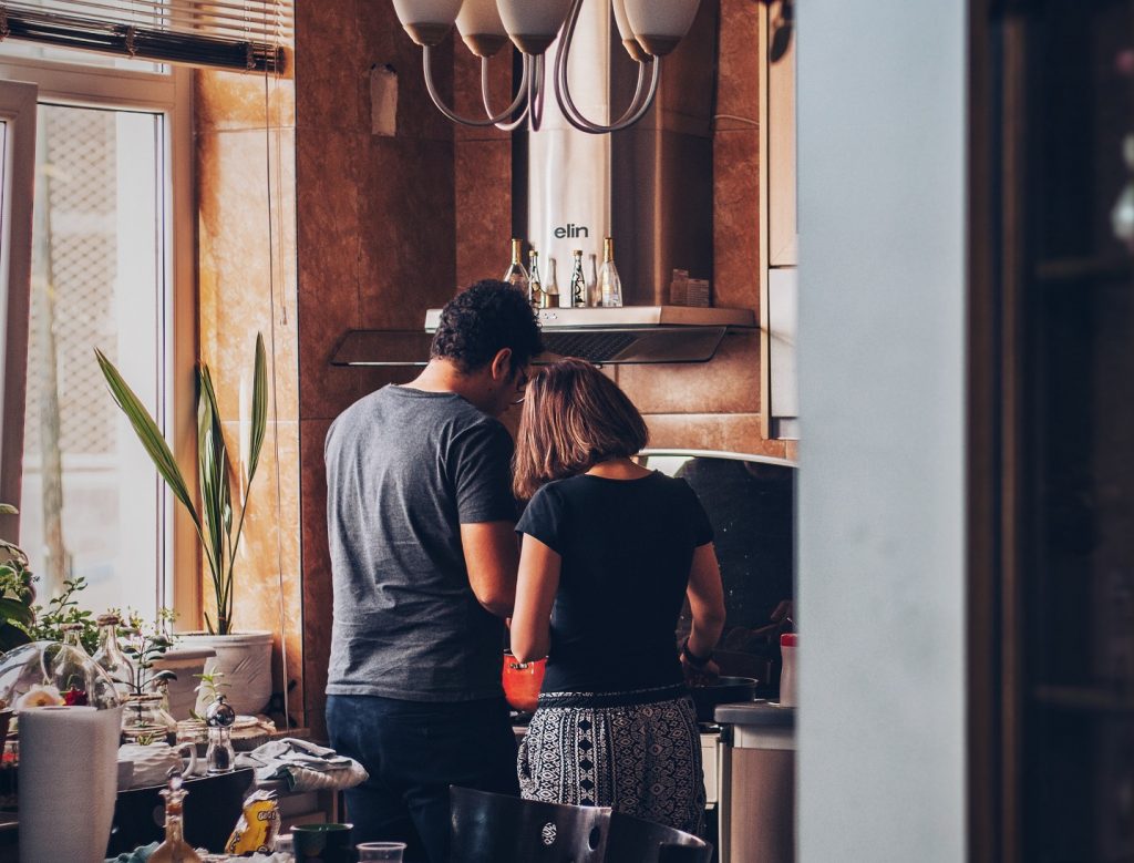 couple in kitchen standing side by side, ways to show love