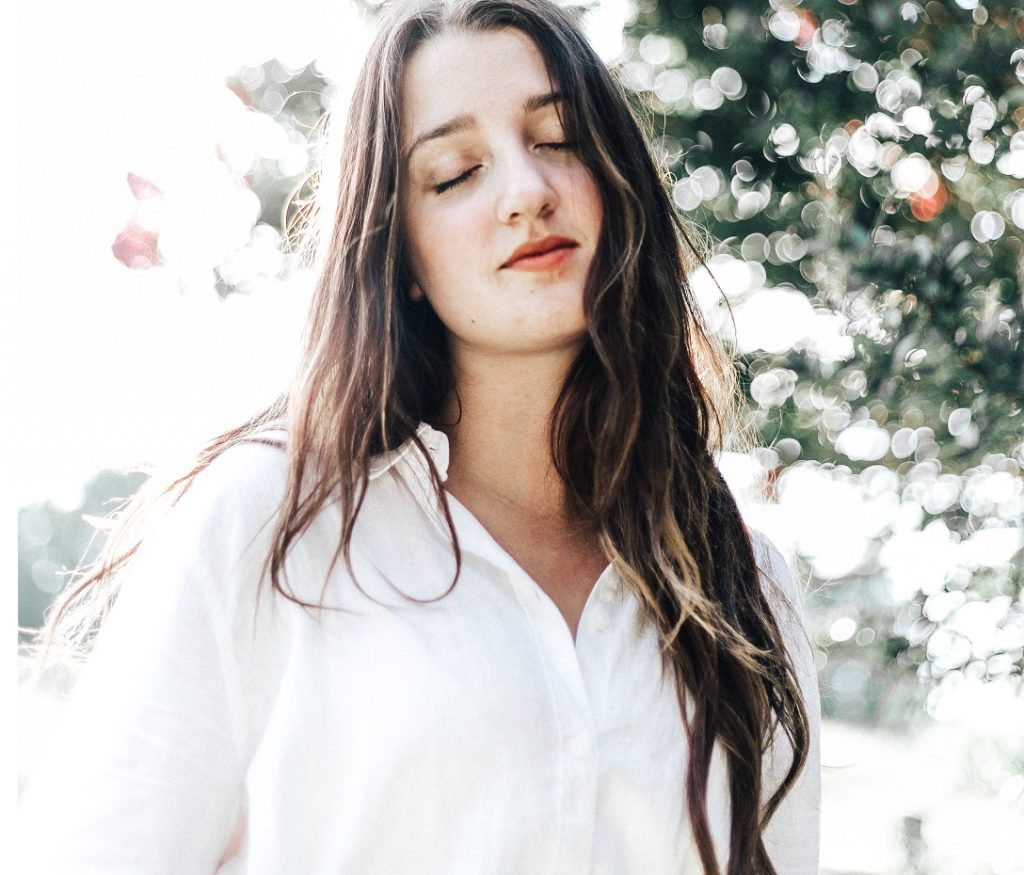 girl with eyes closed smiling, take chances