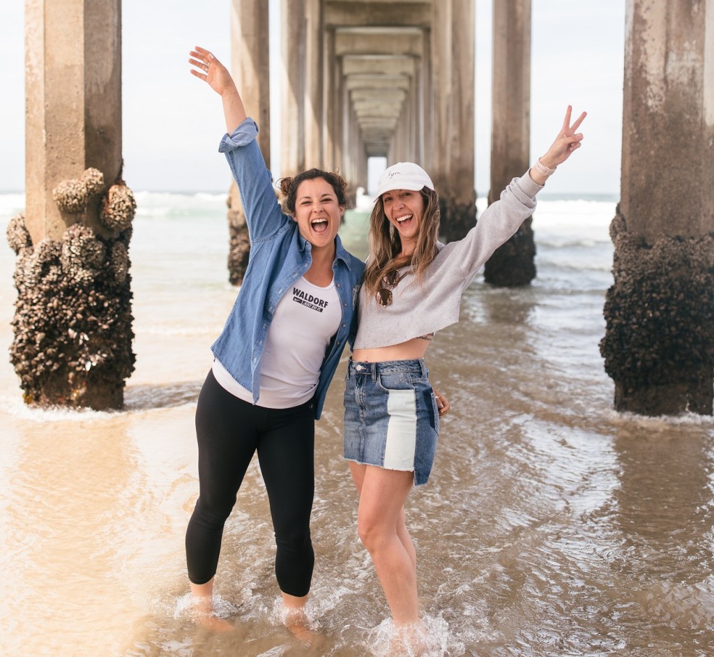 happy girls dancing in the water