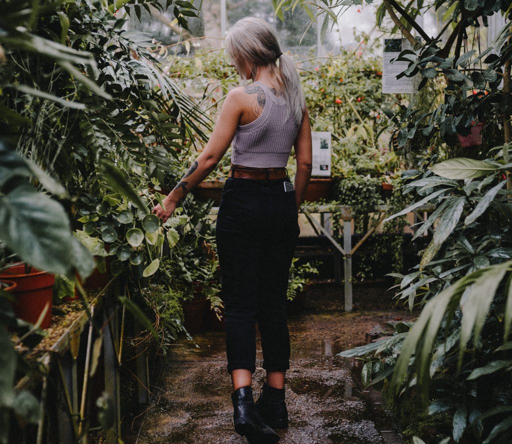 declutter your life, girl walking through garden