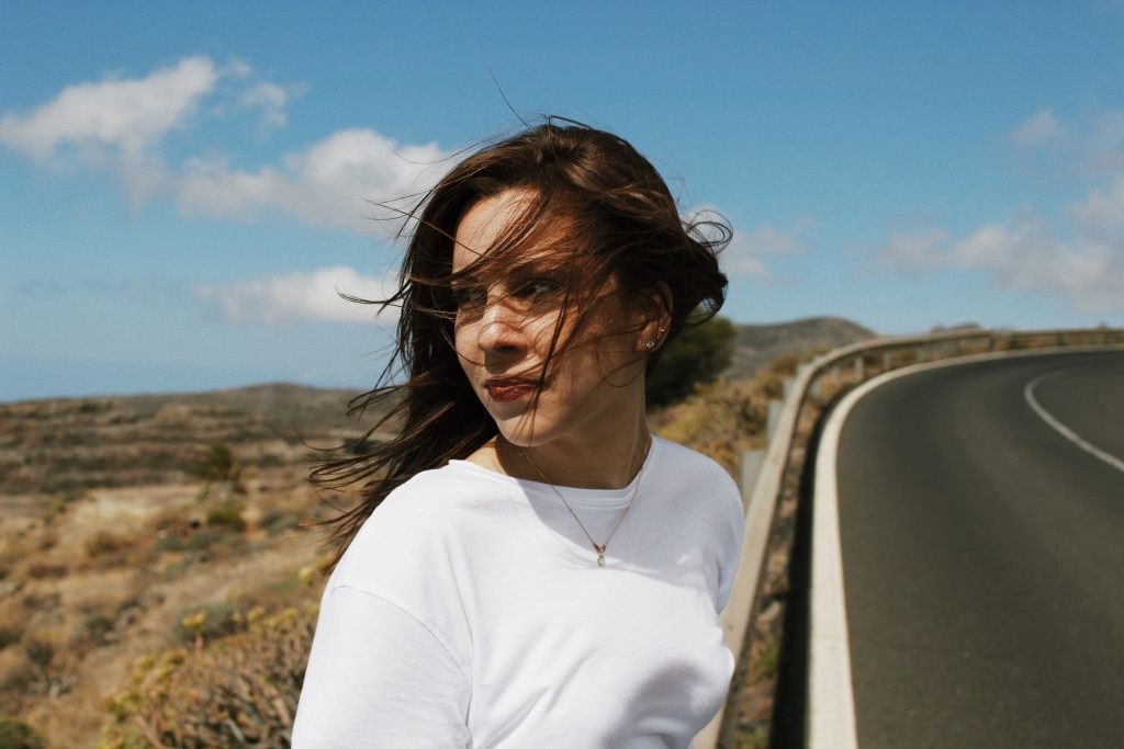 self-worth is found in you, girl looking at street with wind in her hair