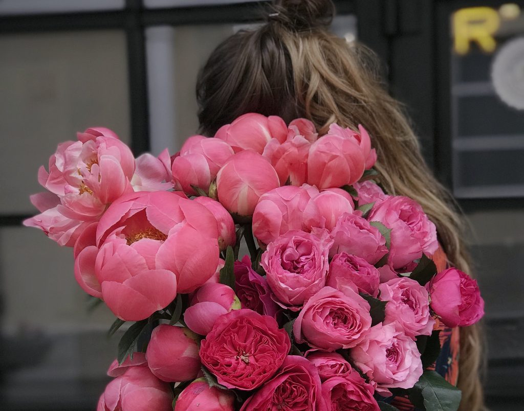 stop beating yourself up for being human, girl holding flowers