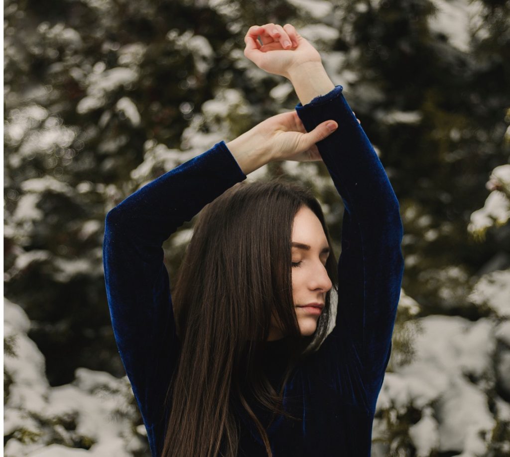 peaceful woman arms above her head, de-stress this holiday season
