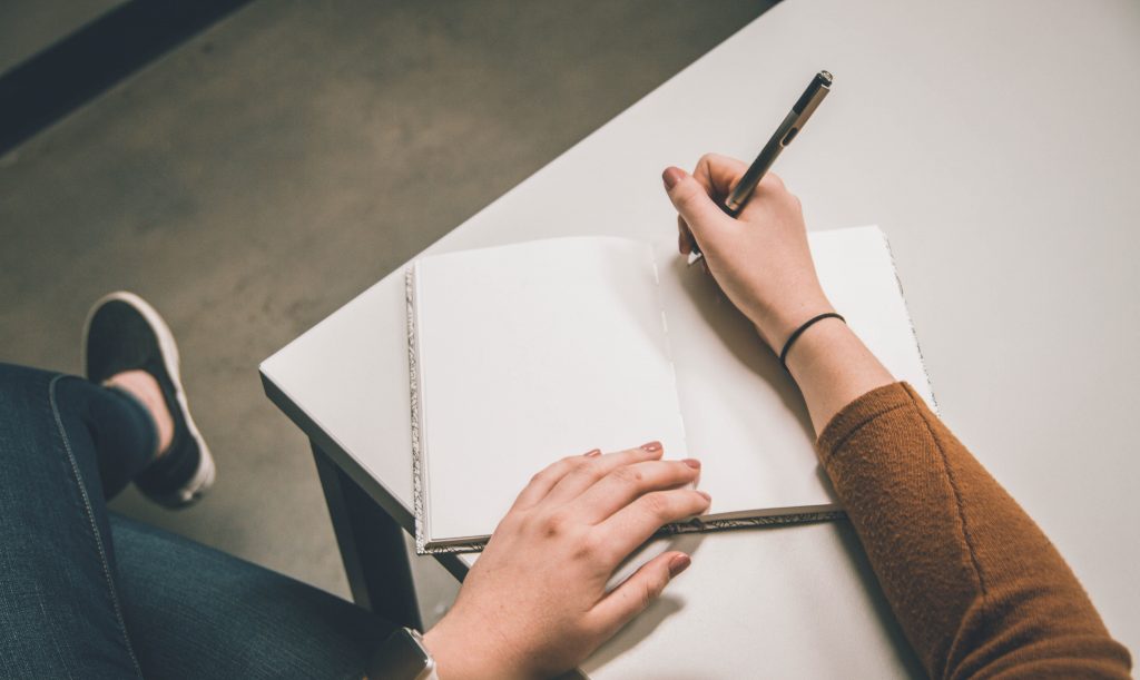 this is why I write, girl with notebook on table