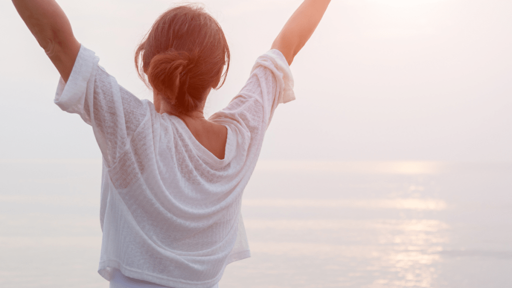 joyful woman with arms up