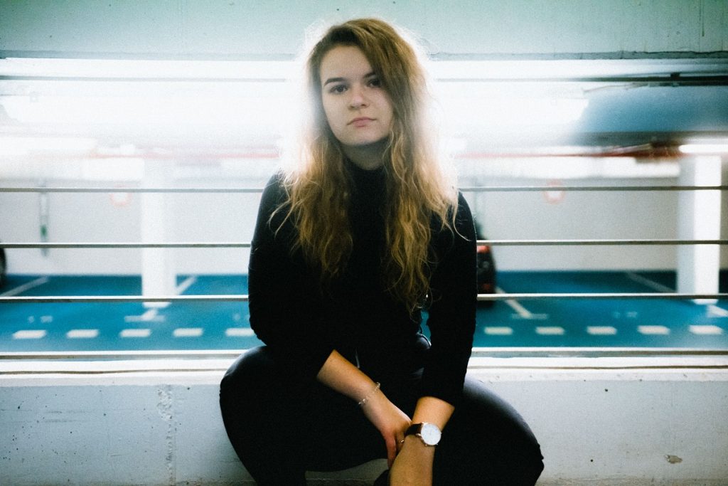 somber woman in black looking at camera, you don't have to be everything