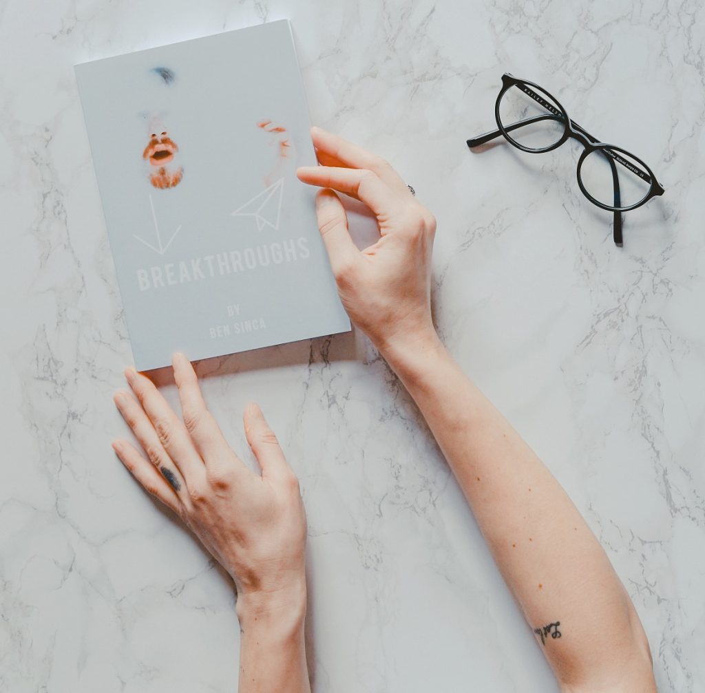 person with hands on book, january 2019 reading list