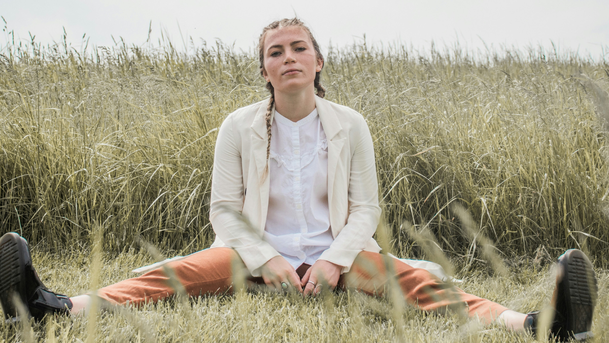 woman sitting in a field who feels like the second choice