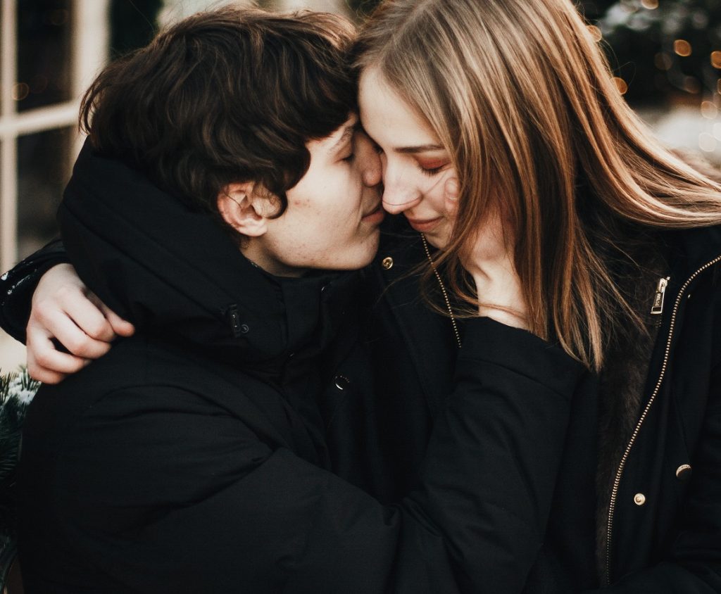 couple holding one another's faces close, love is nothing without the willingness to fight