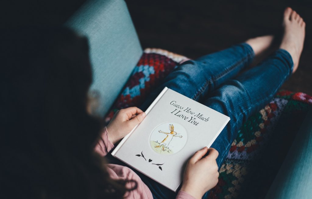 woman holding book on her lap, reading list