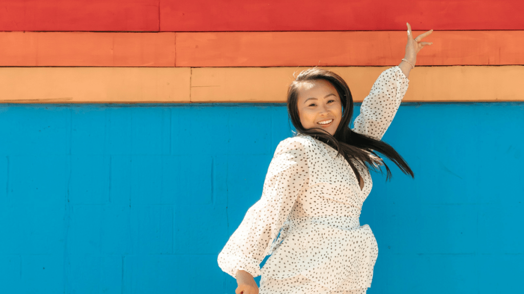 confident woman jumping with a peace sign