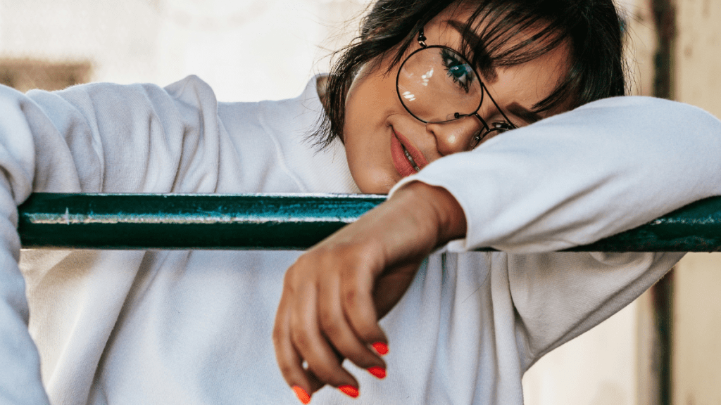 beautiful and imperfect girl hanging on a fence