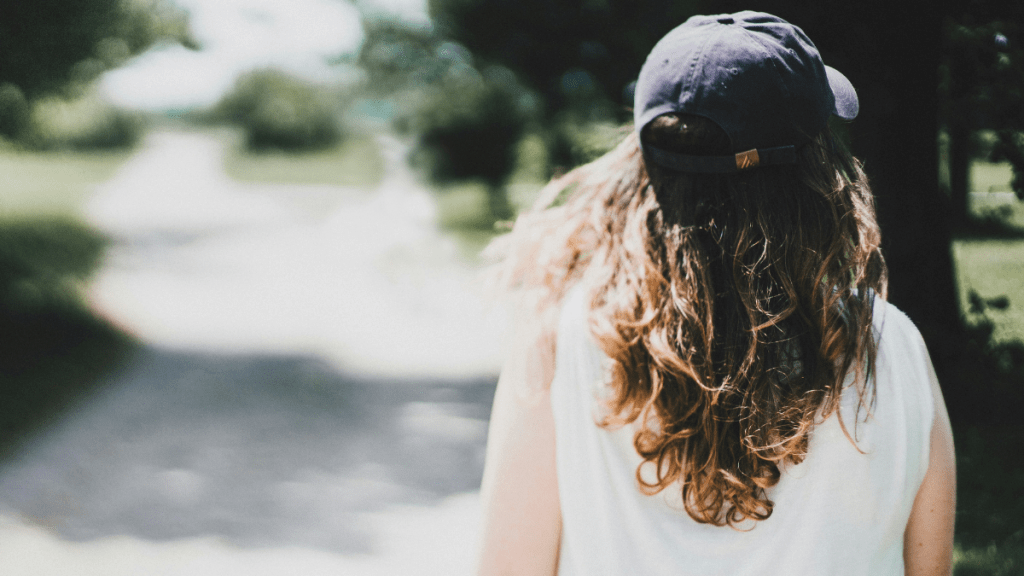 happy woman with a hat celebrating change in difficult seasons
