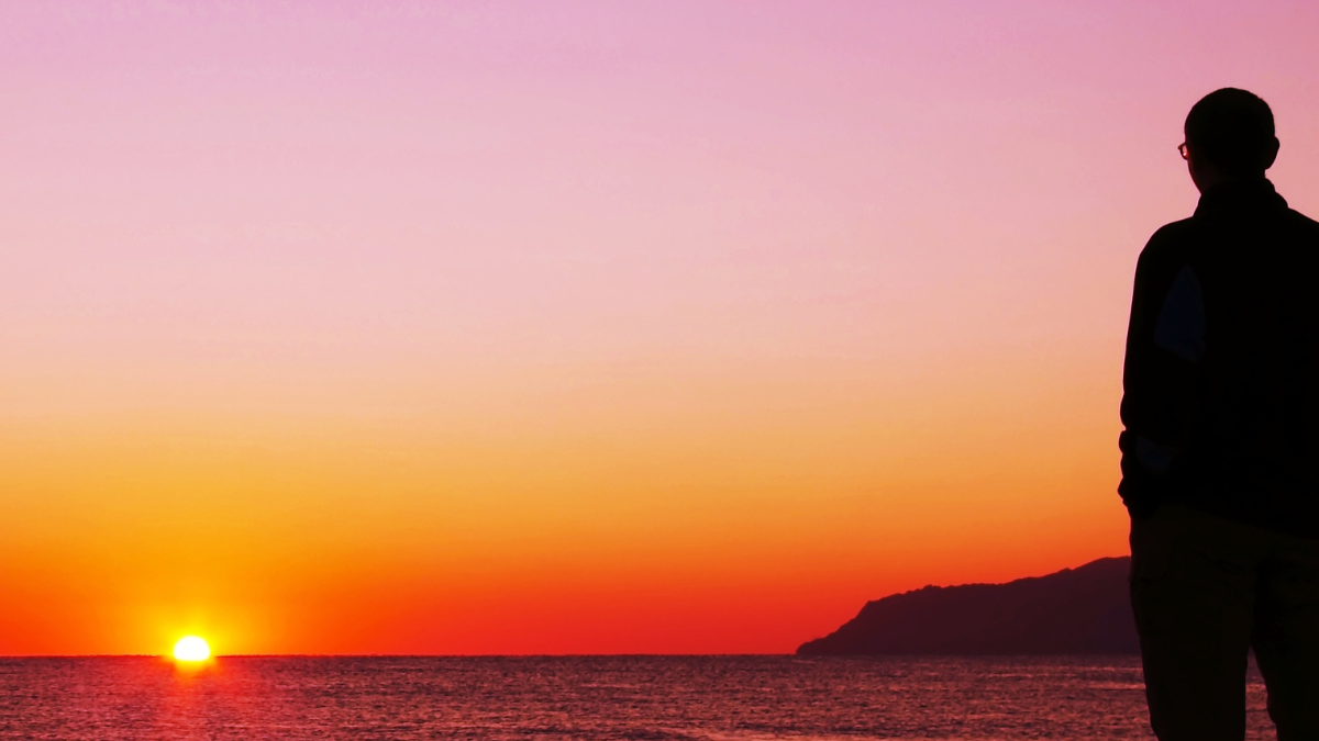 person admiring sunset colours