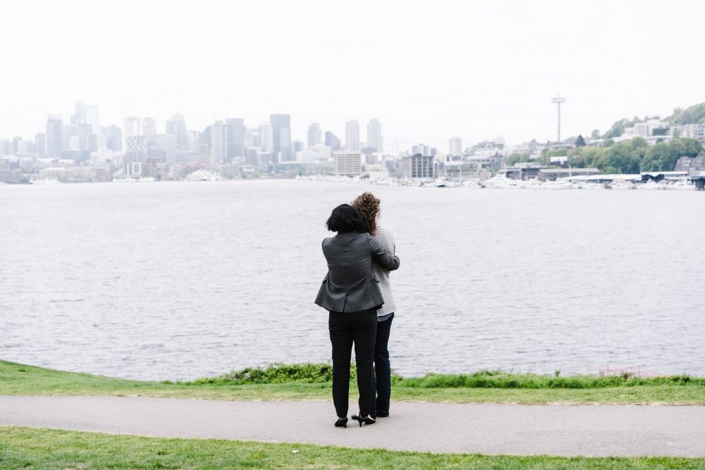 happy couple hugging and learning how to save money living in the city