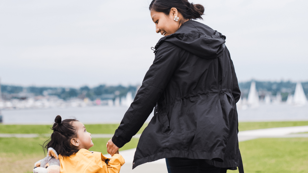 mom walking child in stormy weather