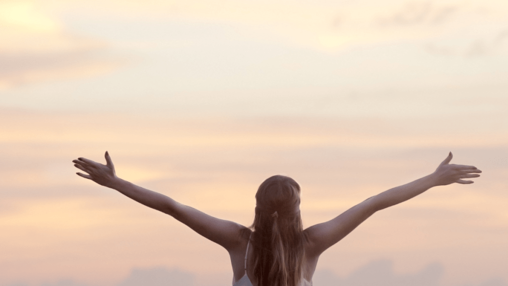 happy woman with arms up in the air