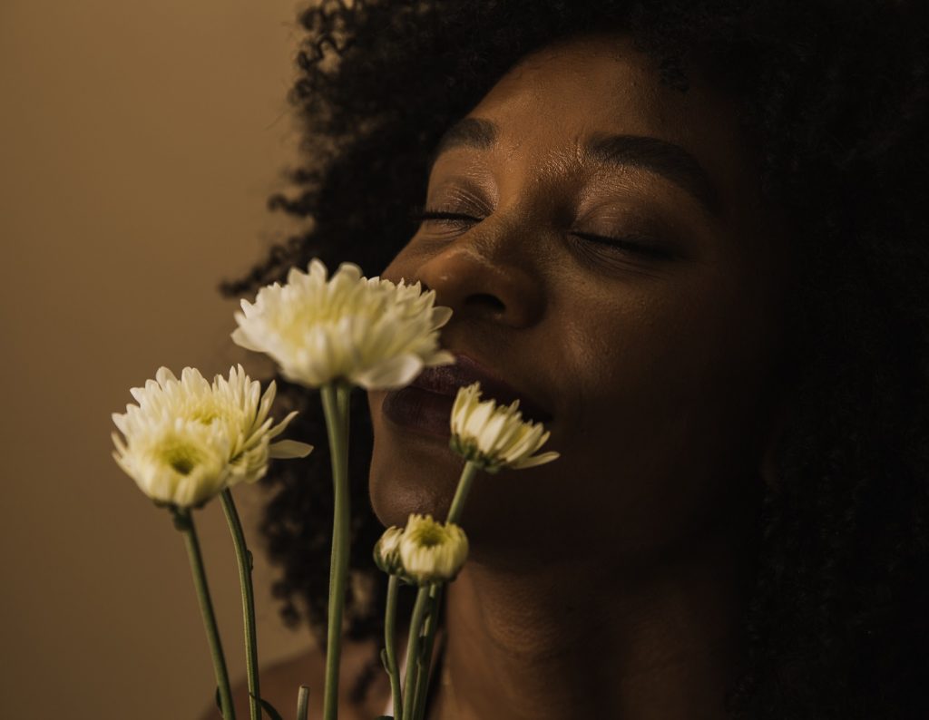 happy woman smelling flowers