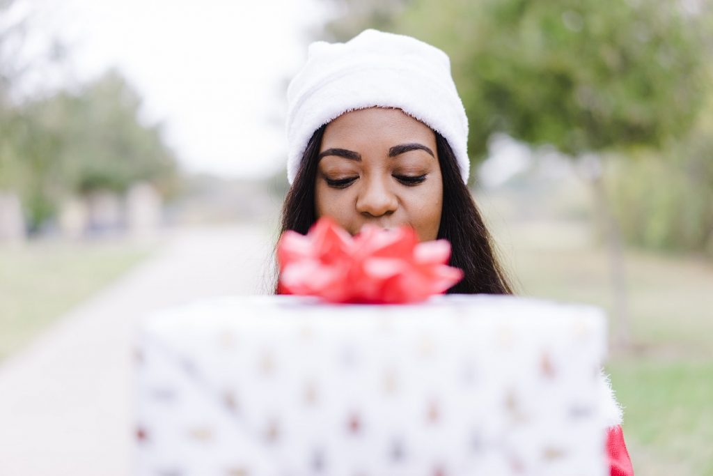 happy woman holding last-minute gifts for Christmas