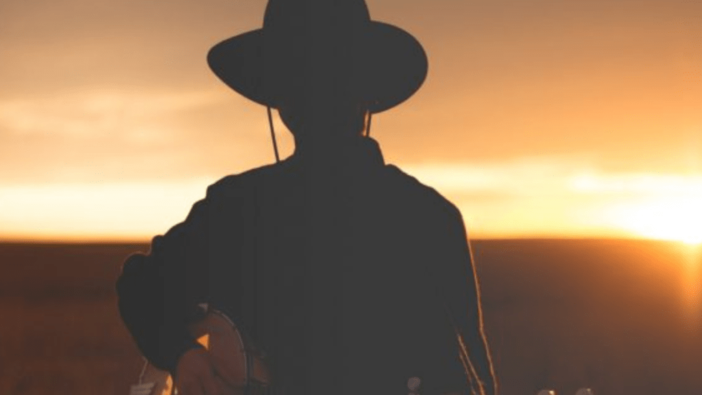 peaceful man with hat at sunset