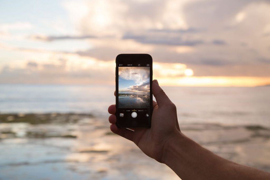 person taking picture excessive social media habits
