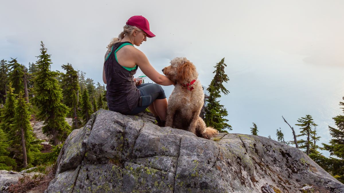 girl trusting in God's perfect timing while hiking with her dog