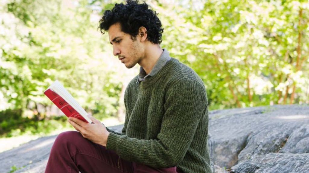 man reading book alone giving self-love
