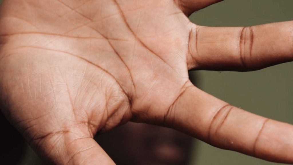 man with hand over his face because of hitting rock bottom