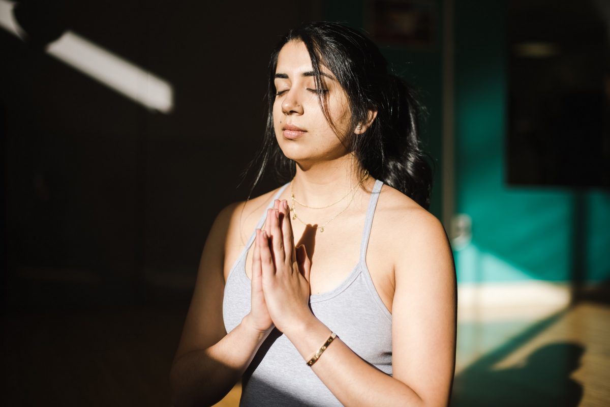 girl meditating finding ways to ease anxiety in stressful times