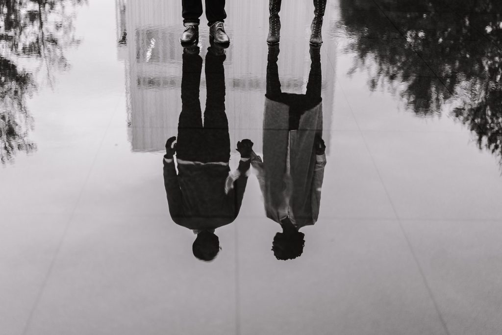 two people holding hands finding ways to feel less lonely