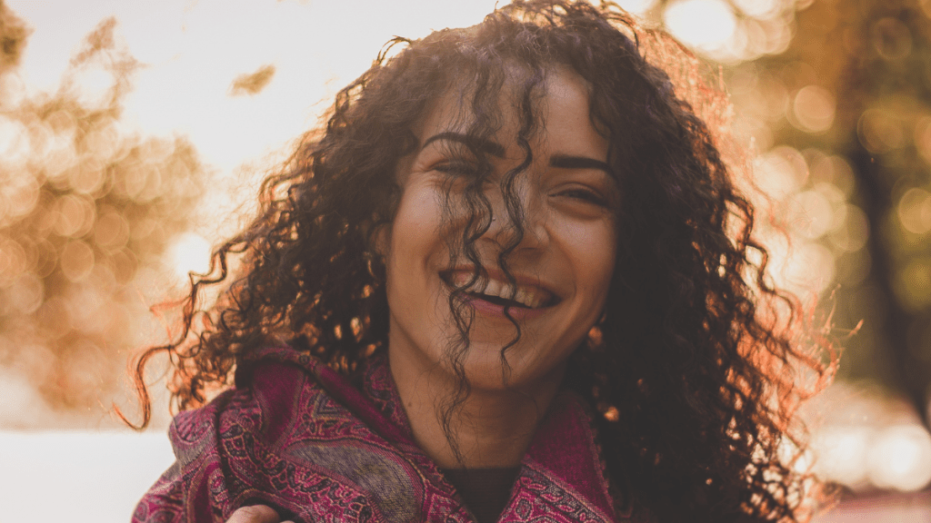 girl smiling and showing what happiness really looks like