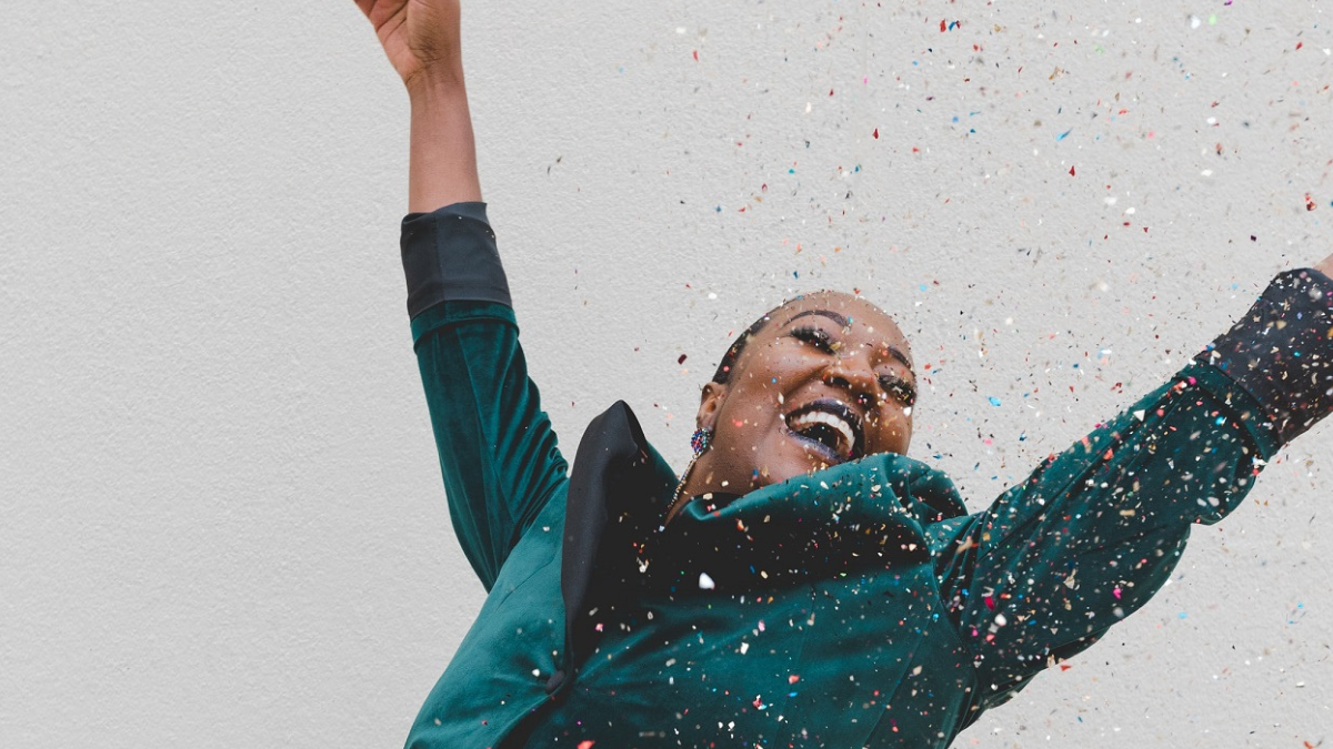happy woman with arms up celebrating her social life
